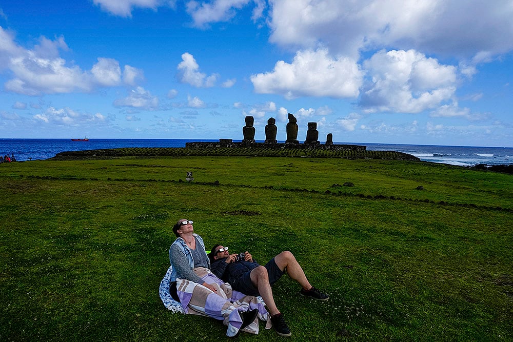 People watch the annular solar eclipse in Tahai, Rapa Nui