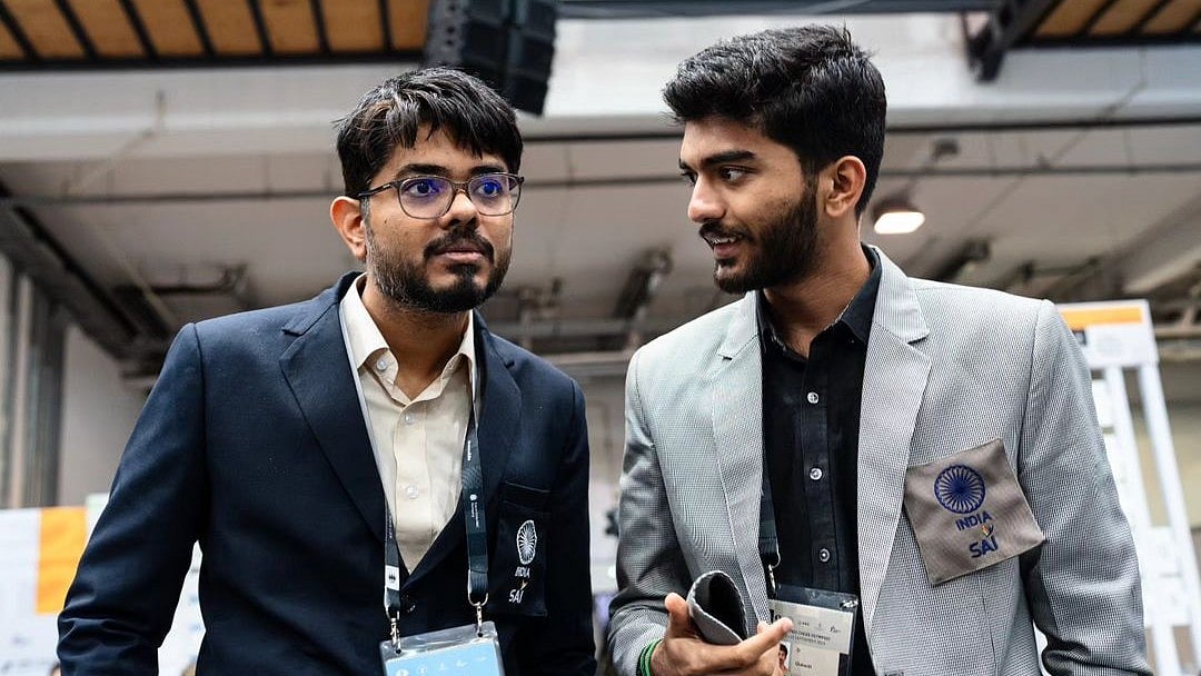 FIDE/Maria Emelianova : File photo of Indian open team captain Srinath Narayanan (left) talking to D Gukesh after a game at the Chess Olympiad in Budapest.