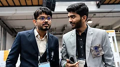 File photo of Indian open team captain Srinath Narayanan (left) talking to D Gukesh after a game at the Chess Olympiad in Budapest (2024). - FIDE/Maria Emelianova