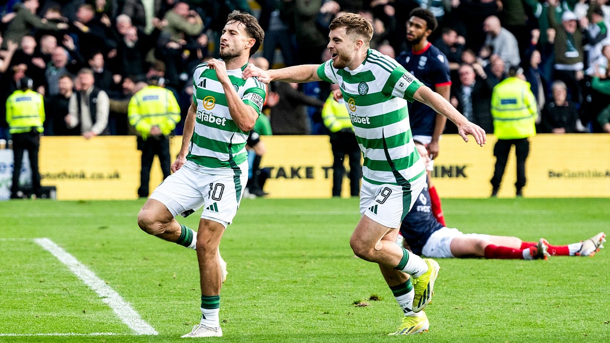 Kuhn and James Forrest celebrate Celtic's winner