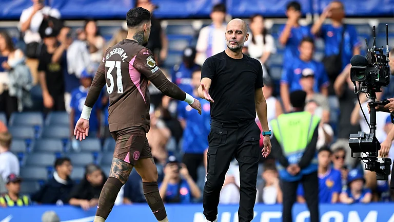 Manchester City goalkeeper Ederson, with manager Pep Guardiola - null