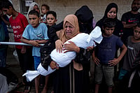 AP : Palestinians mourn relatives killed in the Israeli bombardment of the Gaza Strip, at a hospital in Deir al-Balah, Tuesday, Oct. 1, 2024