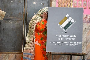 Credits : Parveen Kumar/Hindustan Times via Getty Images : GURUGRAM, INDIA - OCTOBER 5: A woman cast her ballot at a polling station during the Haryana Assembly election at polling station, in Nuh, Mewat, on October 5, 2024 in Gurugram, India. A total of 1,031 candidates are contesting in all 90 assembly constituencies, and 20,632 polling booths have been set up for voting. A total of 2,03,54,350 voters in the state will be able to exercise their rights in the 15th Haryana Legislative Assembly Elections.