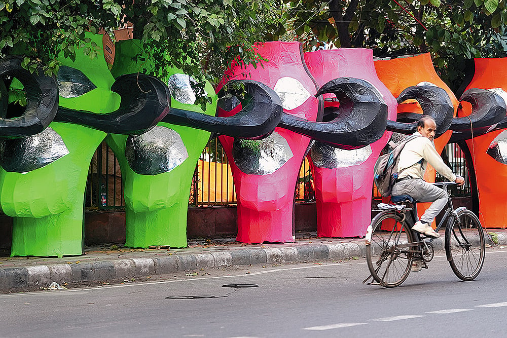 Bright coloured visages of Raavan kept on a pavement