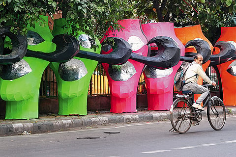 Bright coloured visages of Raavan kept on a pavement