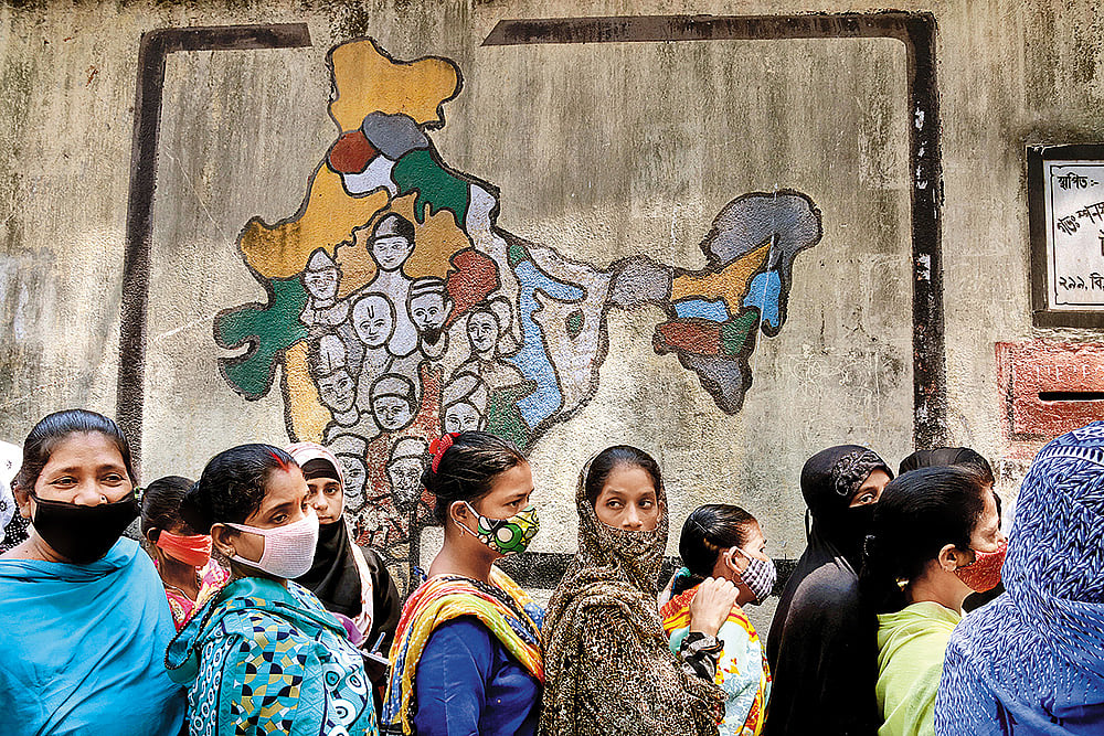 Photo: Getty Images : Participatory Governance: Voters stand in line at a polling station in Kolkata 