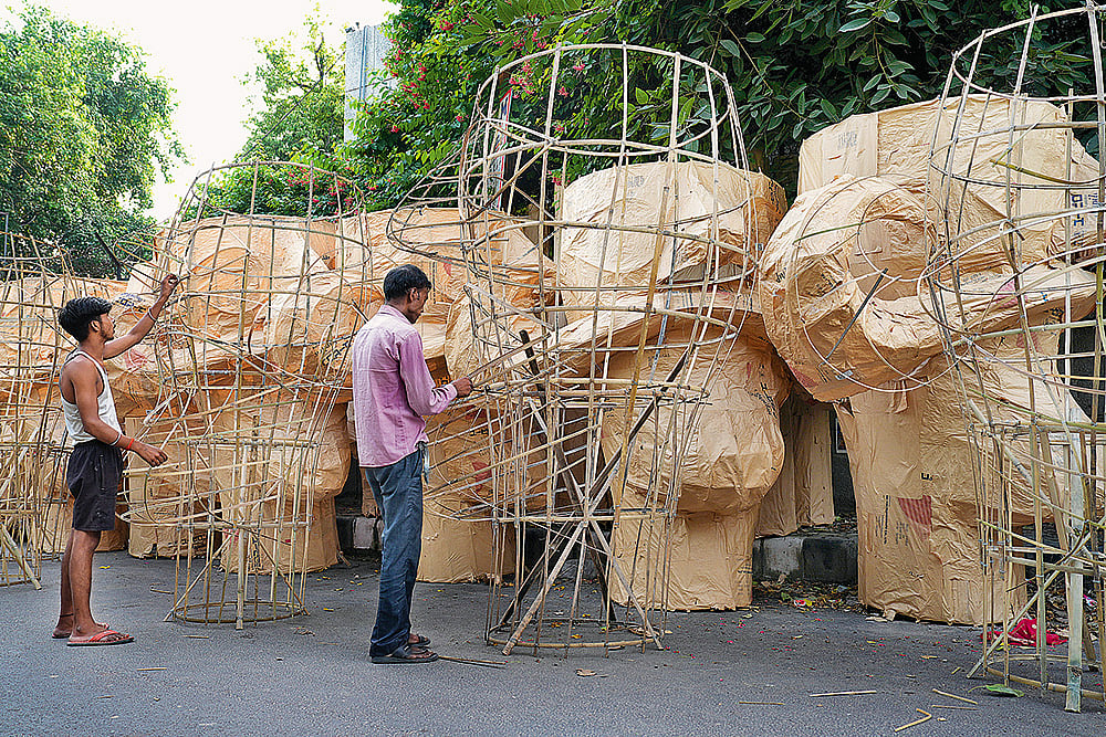 Artisans assemble bamboo sticks before creating an effigy of Raavan