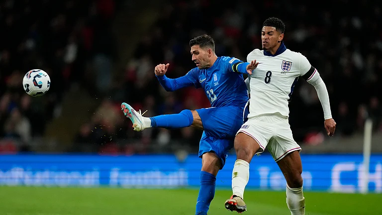 Greece's Tasos Bakasetas, left, and England's Jude Bellingham challenge for the ball during the UEFA Nations League Group F soccer match between England and Greece at Wembley Stadium in London. - AP Photo/Kirsty Wigglesworth