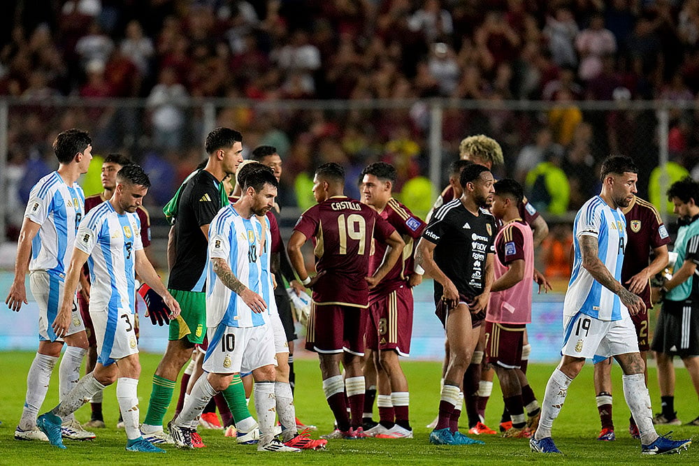 | Photo: AP/Ariana Cubillos : FIFA World Cup 2026 Qualifiers: Argentina's Lionel Messi and teammates walk off the field after draw against Venezuela