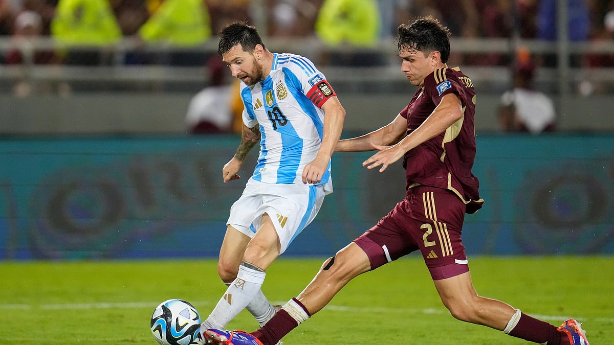 AP Photo/Ariana Cubillos : Argentina's Lionel Messi takes a shot challenged by Venezuela's Nahuel Ferraresi during a FIFA World Cup 2026 qualifying football match in Maturin, Venezuela.
