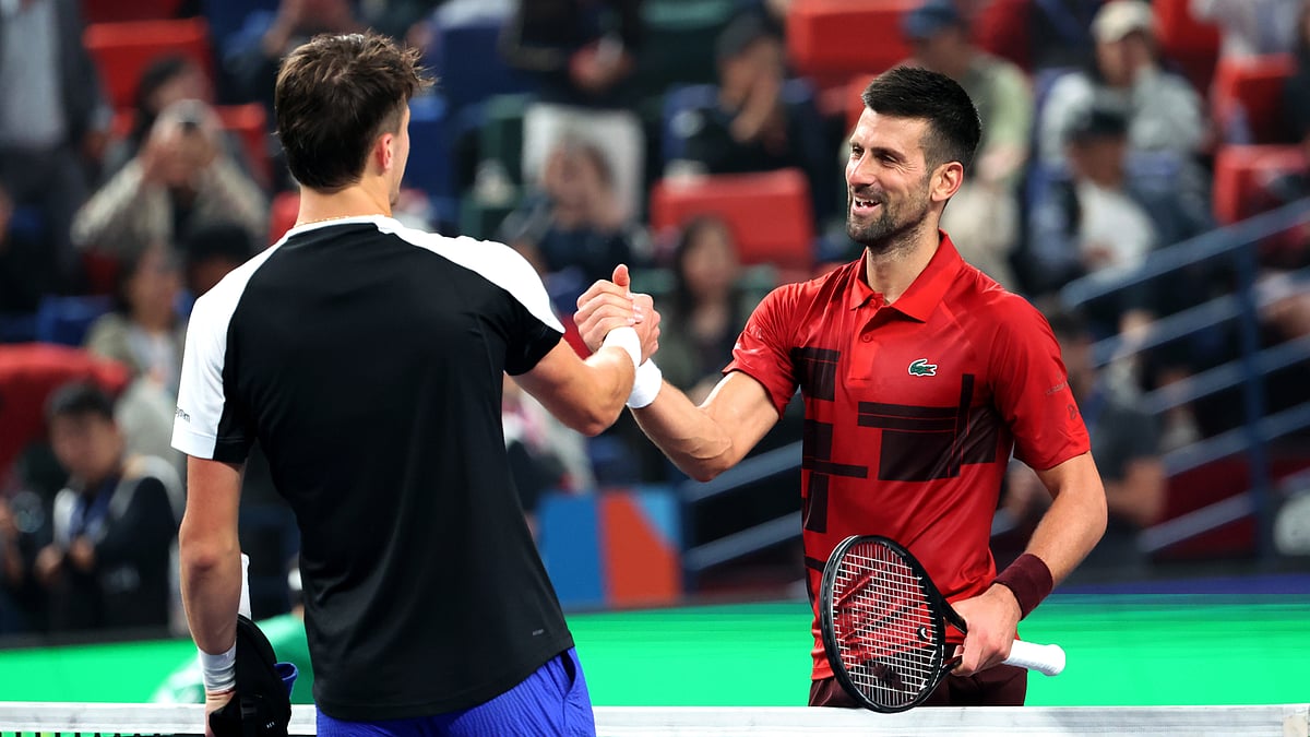 Novak Djokovic and Jakub Mensik embrace after Friday's quarter-final matchup