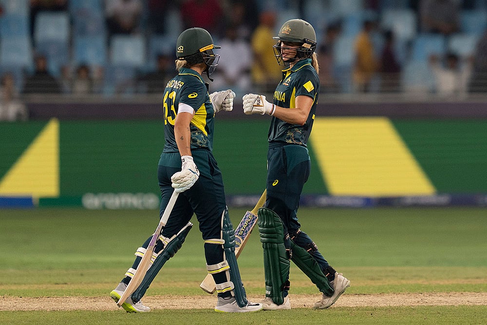 | Photo: AP/Altaf Qadri : Women's T20 World Cup: Australia's Ashleigh Gardner, left, and Beth Mooney bumps their fists to celebrate their win against Pakistan