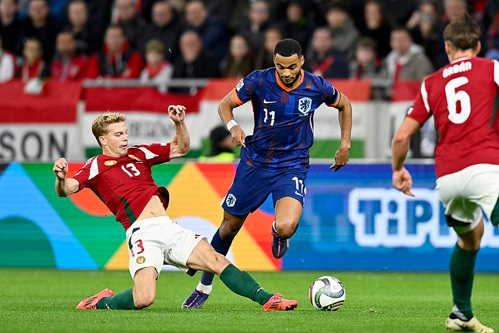 | Photo: AP/Denes Erdos : Nations League Soccer: Hungary's Andras Schafer, left, tries to tackle Cody Gakpo of the Netherlands