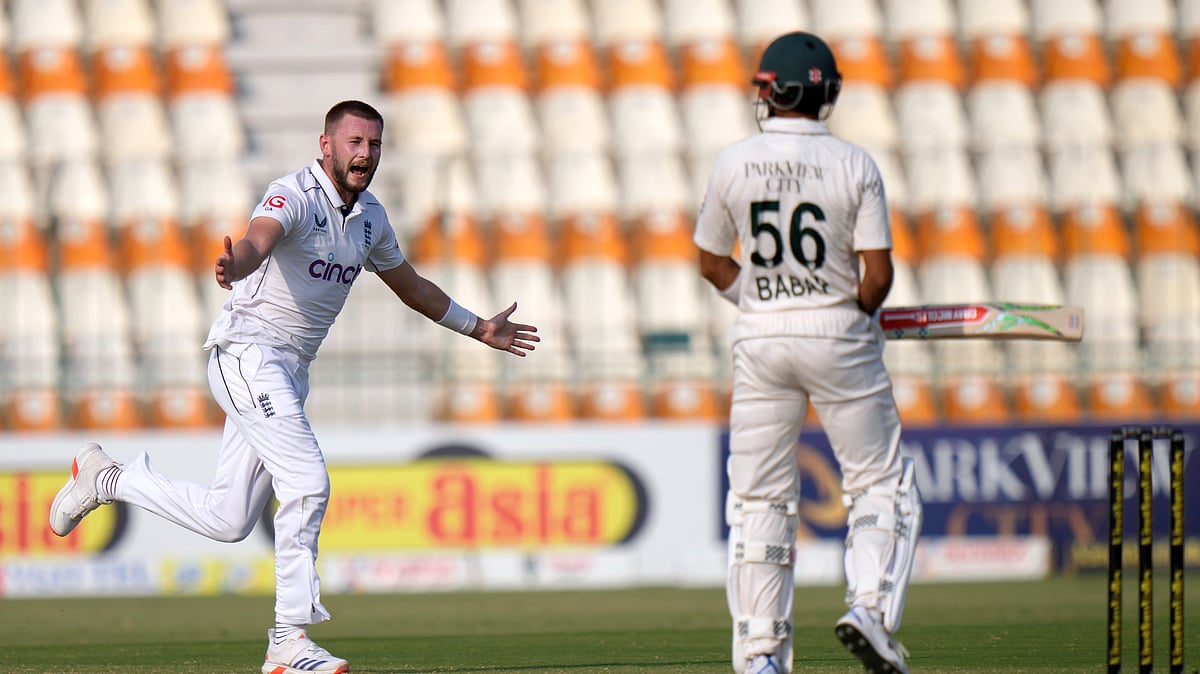 Englands Gus Atkinson, left, celebrates after taking the wicket of Babar Azam. AP Photo