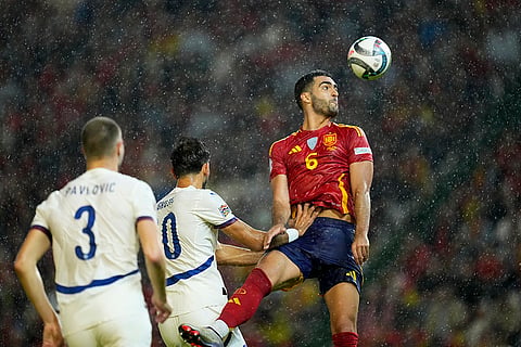 Nations League Soccer: Spain's Mikel Merino, right, jumps for the ball