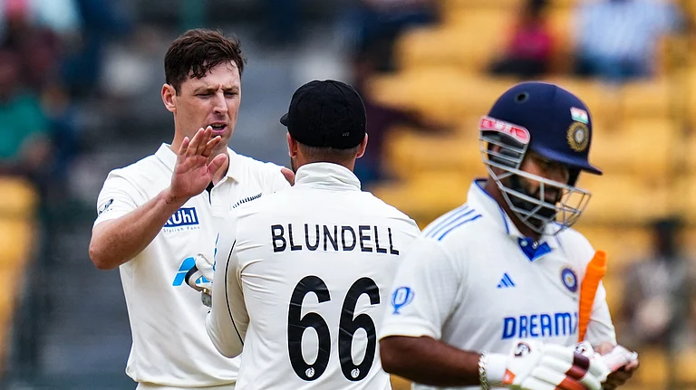 New Zealand's Matt Henry celebrates with teammates after taking the wicket of India's Rishabh Pant during the second day of the first Test cricket match between India and New Zealand, at M Chinnaswamy Stadium, in Bengaluru. - PTI Photo/Shailendra Bhojak