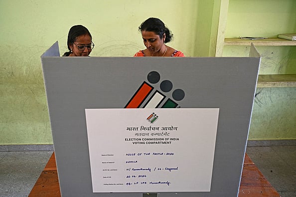 Getty Images : Officials work on an EVM at a polling station in Wayanad district of Kerala, April 25