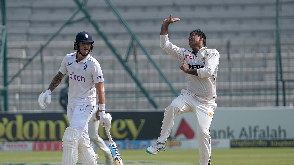 Pakistan's Noman Ali, right, bowls as England's Brydon Carse watches during the fourth day of the second test cricket match between Pakistan and England, in Multan. - AP Photo/K.M. Chaudary
