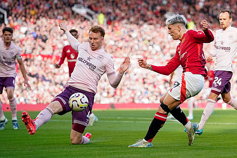 EPL 2024-25: Brentford's Sepp van den Berg, left, tries to block a shot from Manchester United's Alejandro Garnacho