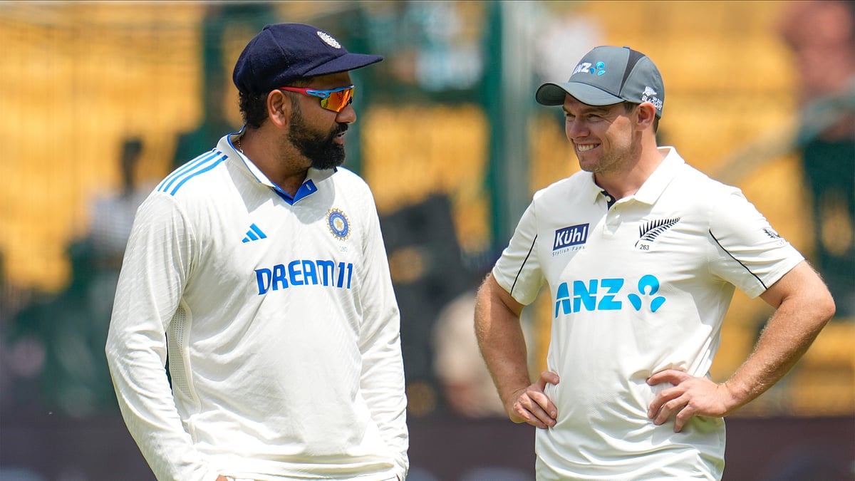 New Zealand's captain Tom Latham, right, speaks to India's captain Rohit Sharma during the post-match ceremony on Day 5 of the first Test at the M. Chinnaswamy Stadium in Bengaluru, Sunday, October. 20, 2024. - AP/Aijaz Rahi