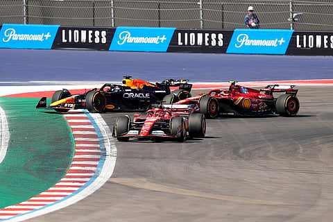 U.S. Grand Prix: Ferrari drivers Charles Leclerc, Carlos Sainz and Red Bull driver Max Verstappen steer wide through a turn to avoid colliding 