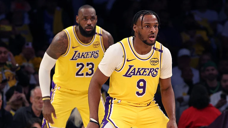 LeBron James #23 and Bronny James #9 of the Los Angeles Lakers on defense during the second quarter against the Minnesota Timberwolves at Crypto.com Arena on October 22, 2024 in Los Angeles, California. - null