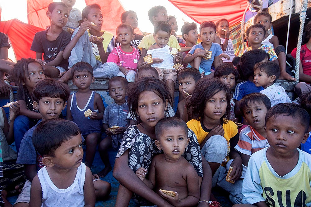 Rohingya refugees: Rohingya refugee children sit on the deck of their boat