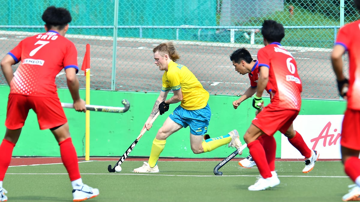 Photo: X | Asian Hockey Federation : Japan hockey players trying to tackle the Australian player during the Sultan of Johor Cup match.