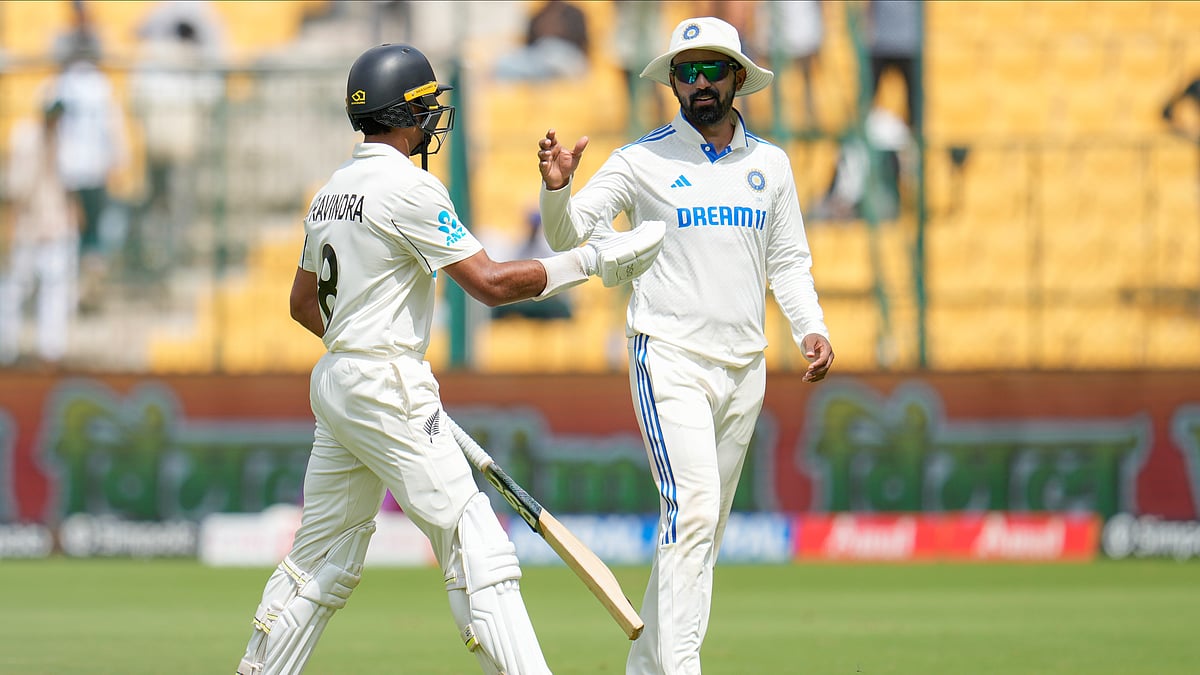 Indias K.L. Rahul, right, congratulates New Zealands Rachin Ravindra. AP Photo