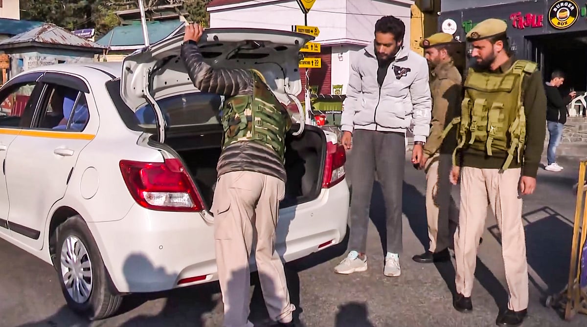 Security personnel check vehicles after a recent terrorist attack.