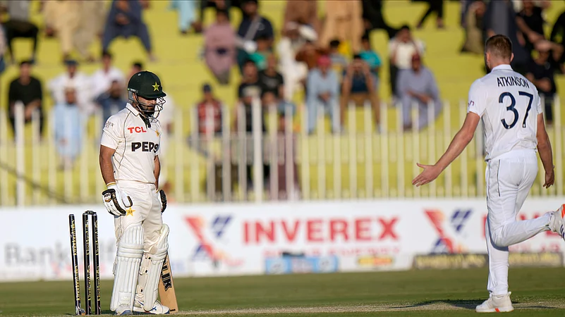 Pakistans Kamran Ghulam, left, reacts as he is bowled out by Englands Gus Atkinson. AP Photo