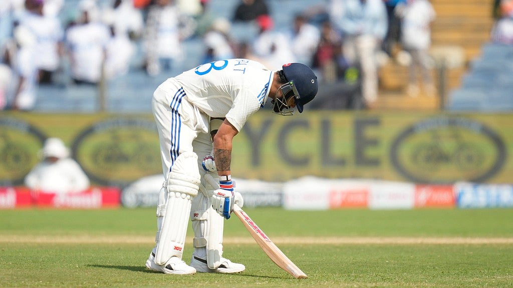 AP : IND vs NZ, 2nd Test: Virat Kohli reacts after being dismissed by Mitchell Santner in Pune.