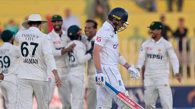 Englands Ollie Pope, second right, reacts as he walks off the field. AP Photo