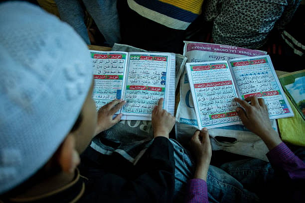 Kashmiri Muslim children read the holy Quran