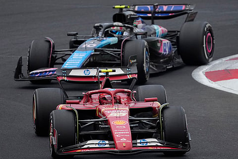 Mexican Grand Prix: Carlos Sainz, of Spain, steers his Ferrari followed by Alpine driver Pierre Gasly of France