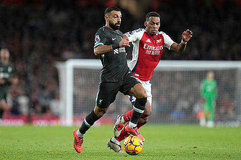 Premier League 2024-25:  Liverpool's Mohamed Salah, left, challenges for the ball with Arsenal's Jurrien Timber