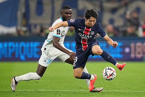Ligue 1 Soccer 2024-25: PSG's Lee Kang-in controls the ball ahead of Marseille's Lilian Brassier 