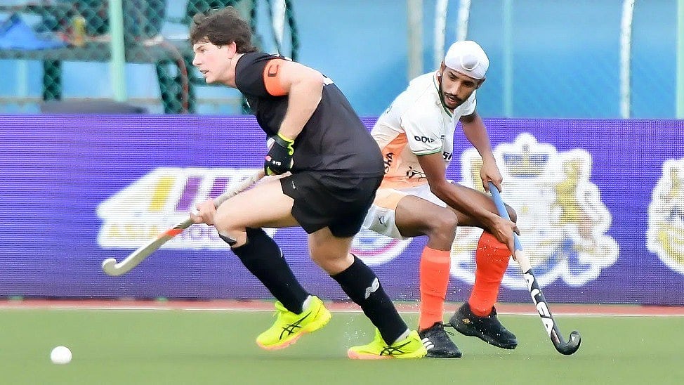 Photo: X | Naveen Patnaik : Indian player trying to go past New Zealand player in Sultan of Johor Cup 2024.