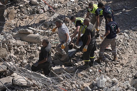 Rescue workers carry the body of a boy in Sarafand