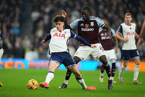 EPL 2024-25: Tottenham's Archie Gray, left, and Aston Villa's Amadou Onana challenge for the ball 