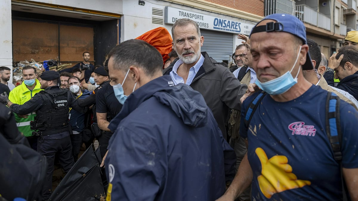 AP : Spanish King Felipe VI, centre, walks amidst angry Spanish flood survivors.