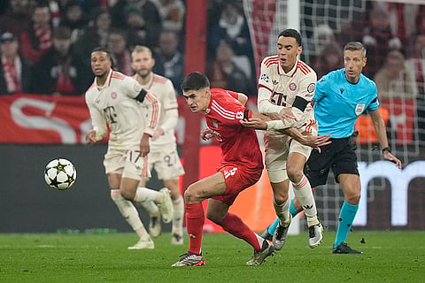 UEFA Champions League: Benfica's Antonio Silva, center, fights for the ball with Bayern's Jamal Musiala