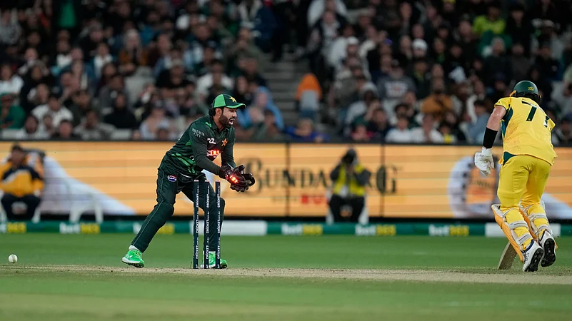 Pakistans Mohammad Rizwan, left, runs out Australias Sean Abbott. AP Photo