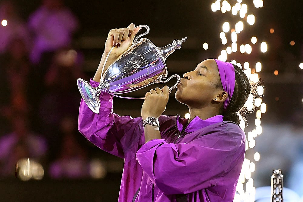 | Photo: AP : WTA Finals: Coco Gauff of the U.S. kisses her trophy after winning against China's Qinwen Zheng