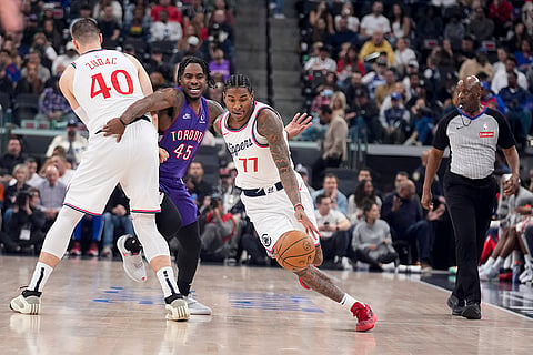 NBA: Clippers guard Kevin Porter Jr. (77) dribbles around a screen set by center Ivica Zubac (40) on Raptors guard Davion Mitchell 