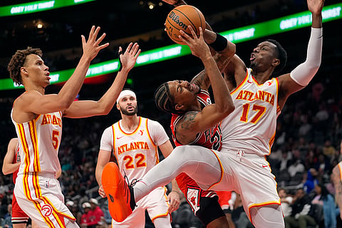 NBA: Bulls forward Dalen Terry (25) tries to bet past Hawks forward Onyeka Okongwu