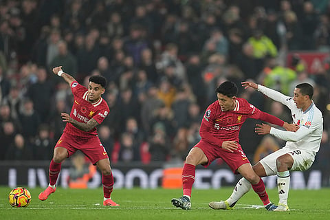 EPL 2024-25: Liverpool's Wataru Endo, center, and Aston Villa's Youri Tielemans battle for the ball 