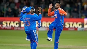 AP : Varun Chakravarthy, right, celebrates with captain Suryakumar Yadav the dismissal of Heinrich Klaasen during the second T20I between South Africa and India at St George's Park in Gqeberha.
