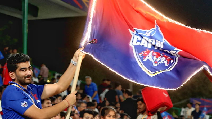 A Delhi Capitals fan waving his teams flag