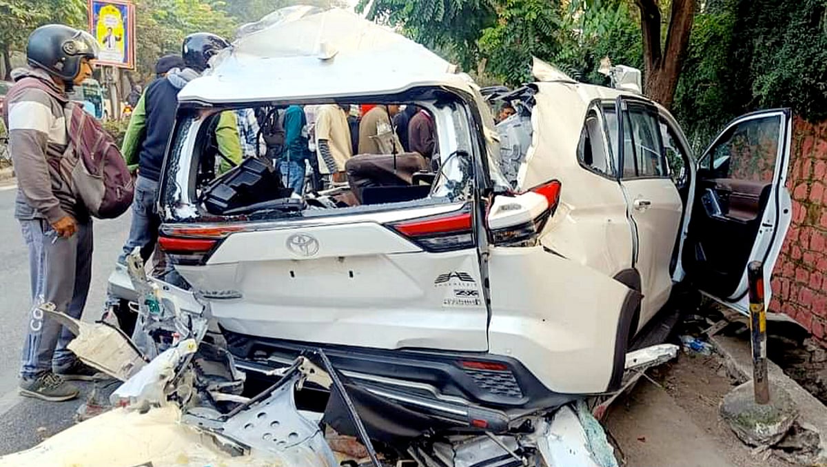 PTI : People near the wreckage of the vehicle after a car collided with a container truck, at ONGC Chowk in Dehradun, early Tuesday, Nov 12, 2024. 